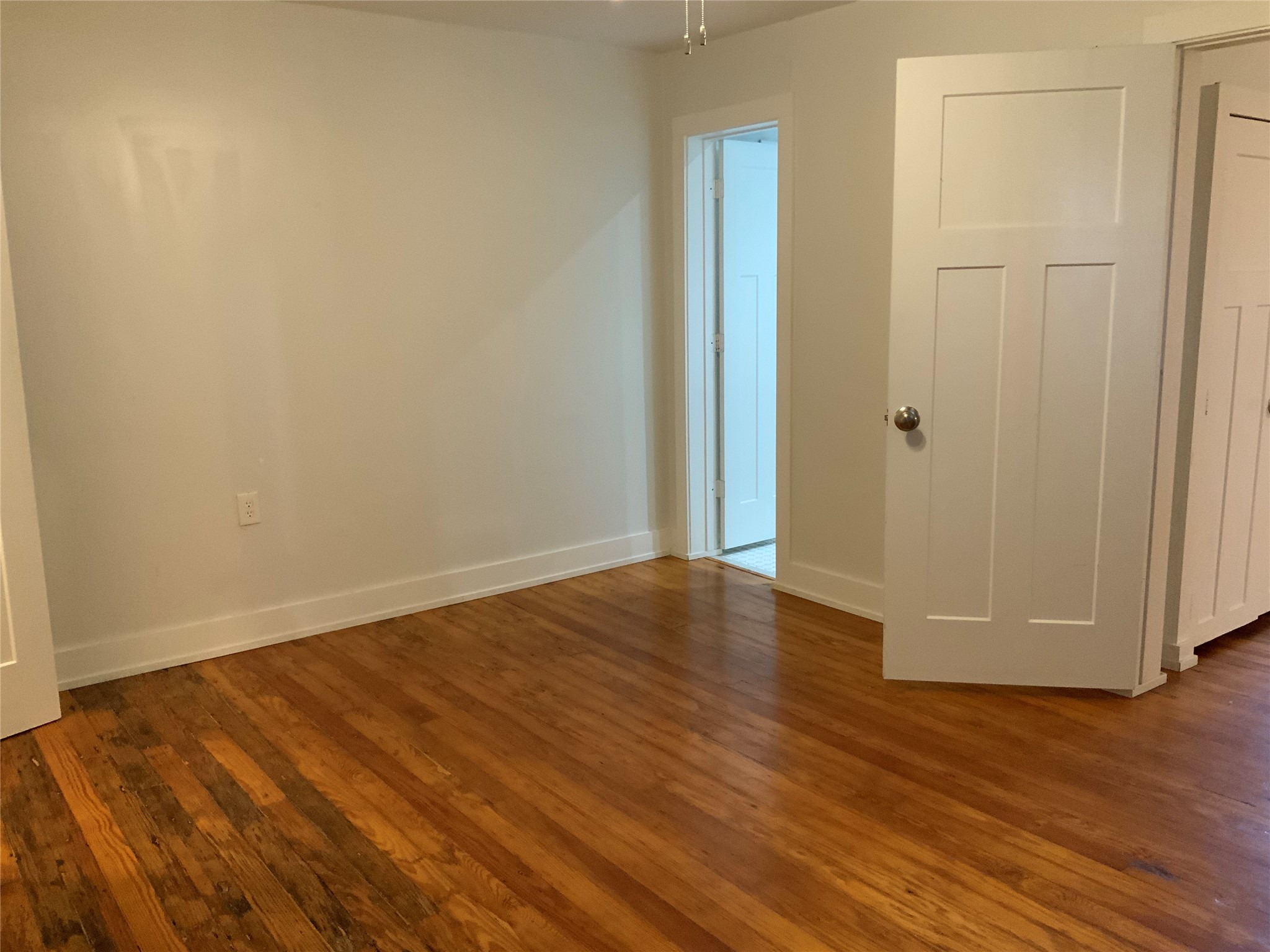 100 West Madison Street, Unit A Trinity, TX 75862 - Photo 21 of 24 a view of a room with wooden floor and white doors