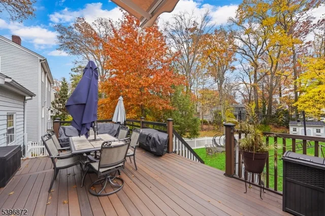 a view of a patio with table and chairs and wooden floor