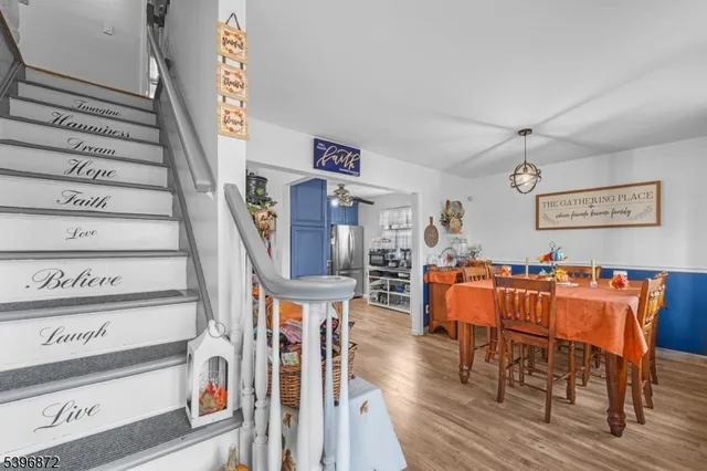 a view of a room with furniture and wooden floor