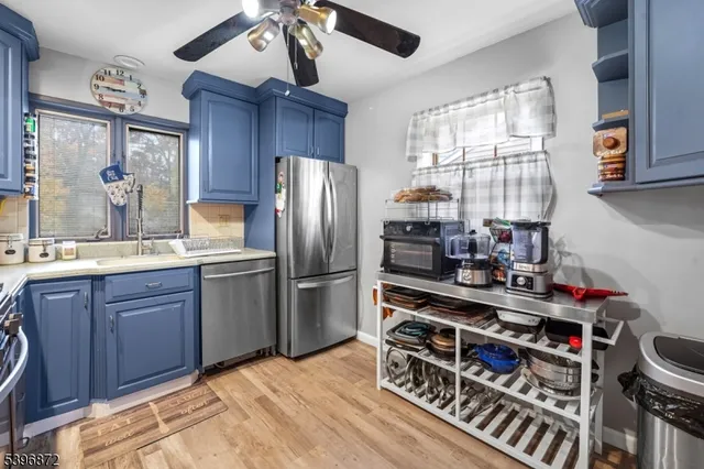 a kitchen with stainless steel appliances a refrigerator and a stove