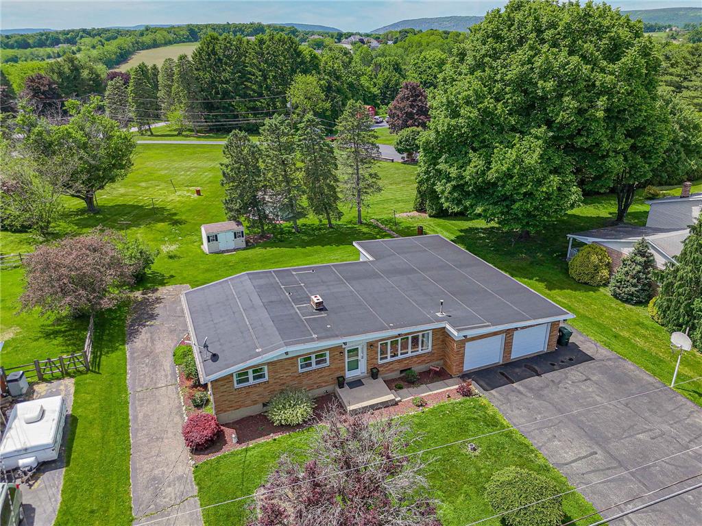 579 Cherry Road Northampton, PA 18067 - Photo 5 of 57 Perched on a verdant lot, this single-level home offers expansive outdoor areas and a convenient two-car garage.