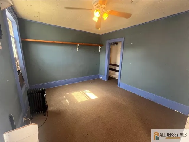 a view of room with a ceiling fan and window