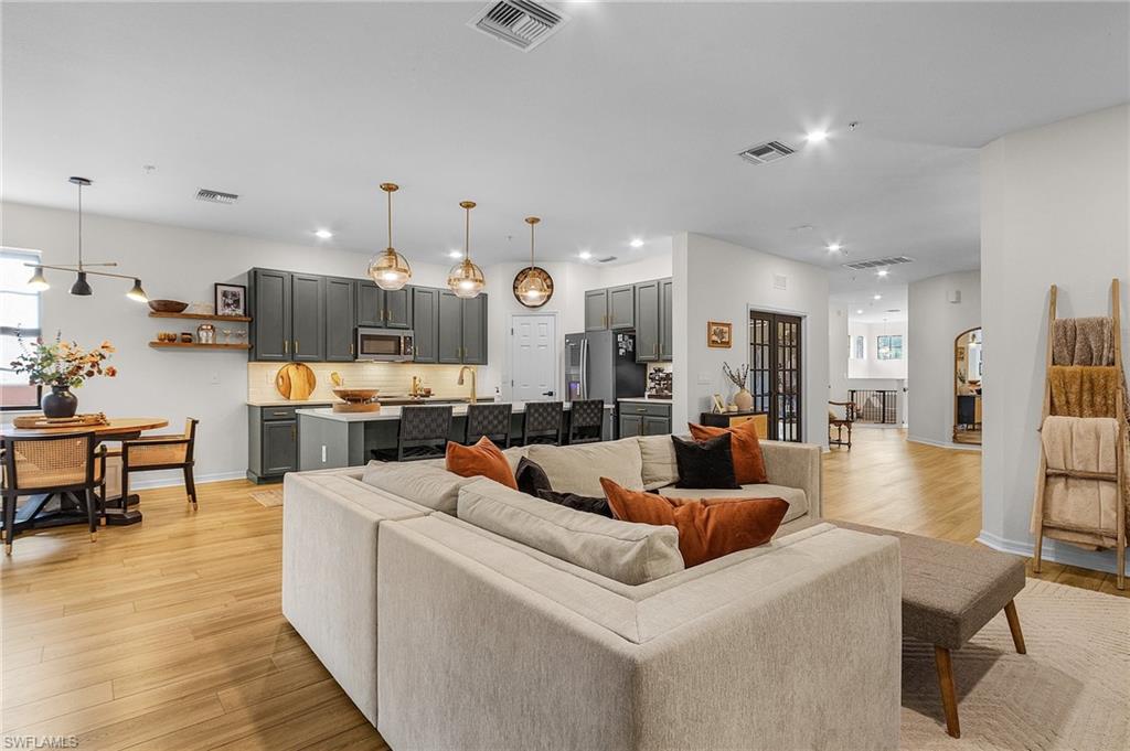 3793 Costa Maya Way, Unit 202 Estero, FL 33928 - Photo 14 of 28 a living room with furniture and kitchen view
