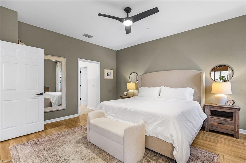 3793 Costa Maya Way, Unit 202 Estero, FL 33928 - Photo 16 of 28 a bedroom with a large bed and ceiling fan