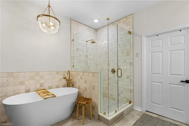 a bathroom with a shower a bathtub and shower