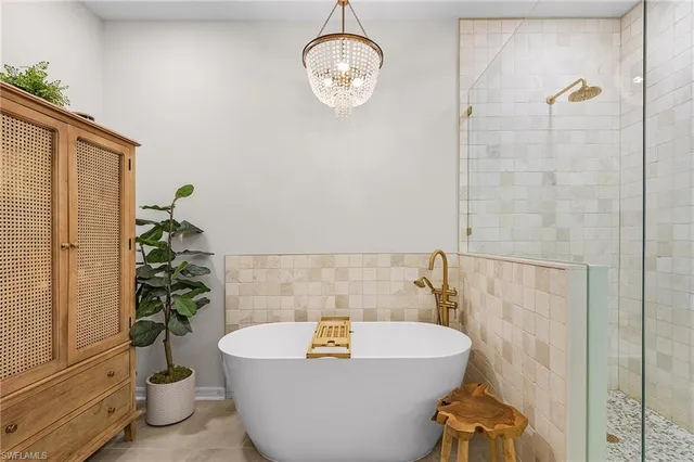 a bath tub sitting in a bathroom next to a window