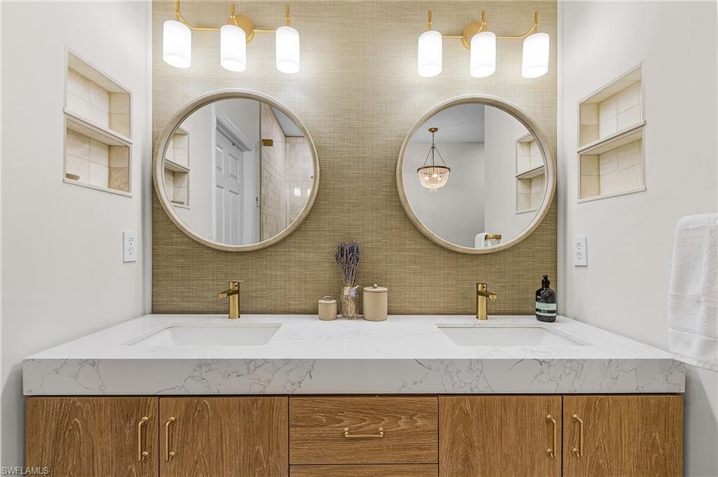 3793 Costa Maya Way, Unit 202 Estero, FL 33928 - Photo 19 of 28 a bathroom with a granite countertop double vanity sinks and a mirror
