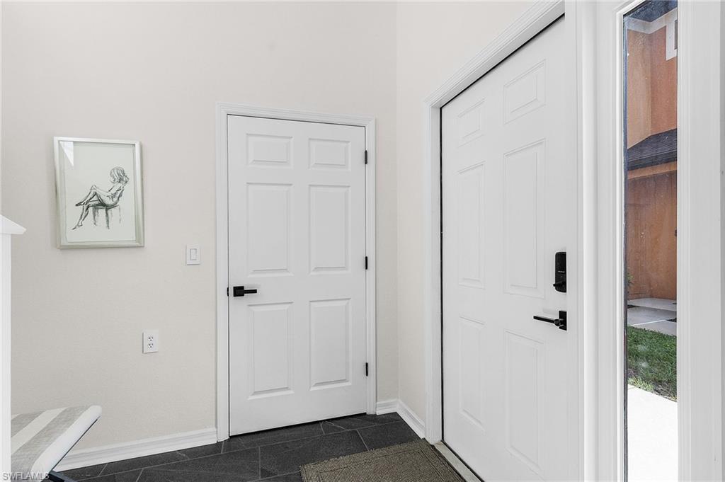 3793 Costa Maya Way, Unit 202 Estero, FL 33928 - Photo 20 of 28 a view of a hallway with wooden floor and closet