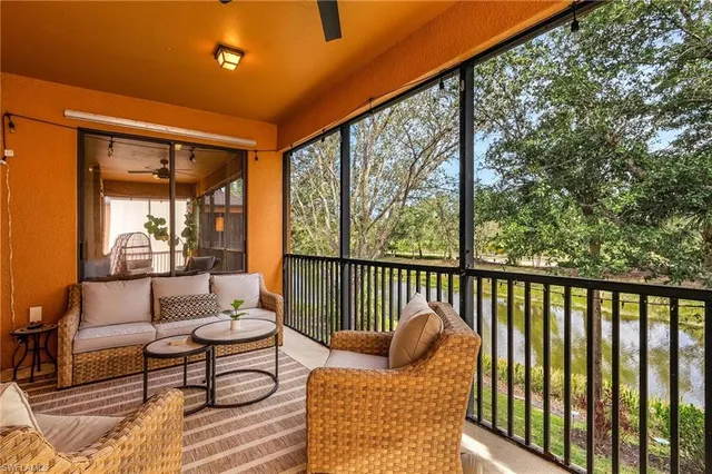 a balcony with wooden floor and outdoor seating