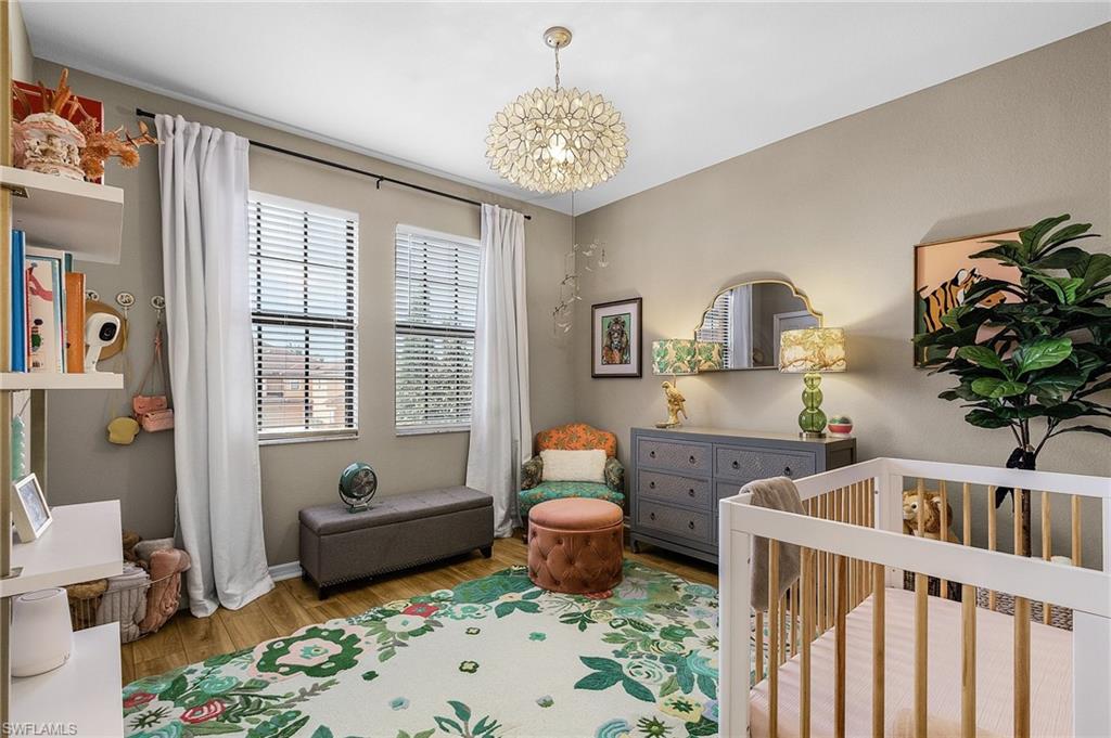 3793 Costa Maya Way, Unit 202 Estero, FL 33928 - Photo 7 of 28 a bedroom with furniture and a large window