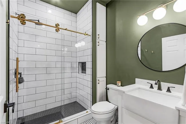 a bathroom with a sink mirror toilet and shower