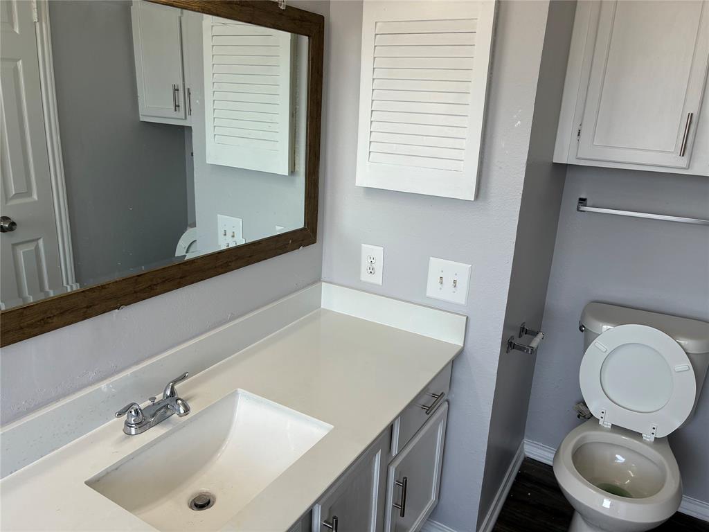 6108 Abrams Road, Unit 306 Dallas, TX 75231 - Photo 14 of 17 Half bathroom with vanity and toilet