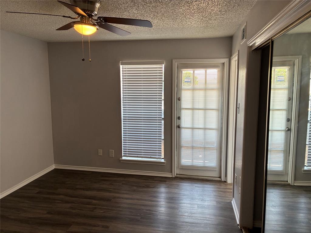 6108 Abrams Road, Unit 306 Dallas, TX 75231 - Photo 16 of 17 Spare room with a textured ceiling, dark wood finished floors, and a ceiling fan
