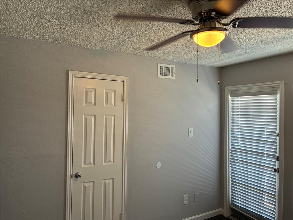 6108 Abrams Road, Unit 306 Dallas, TX 75231 - Photo 10 of 17 Unfurnished room featuring a ceiling fan and a textured ceiling
