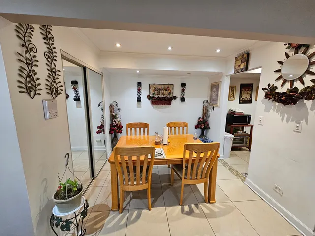 a view of a dining room with furniture and a potted plant
