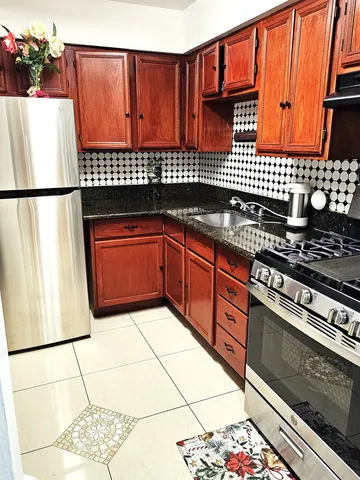 a kitchen with stainless steel appliances granite countertop a stove a sink and dishwasher
