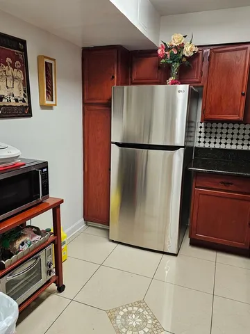 a kitchen with a refrigerator and a stove