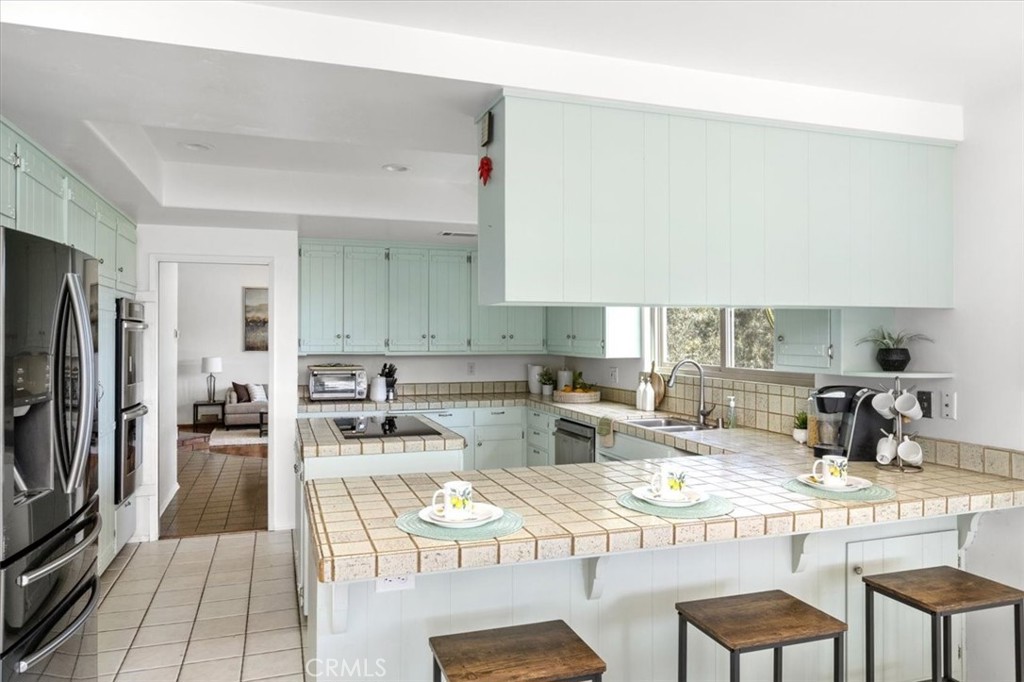3240 Skycrest Drive Fallbrook, CA 92028 - Photo 11 of 40 a kitchen with stainless steel appliances kitchen island granite countertop a sink and cabinets