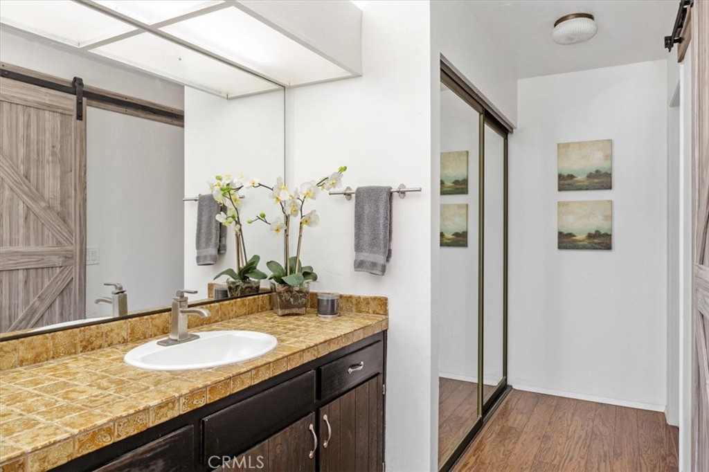 3240 Skycrest Drive Fallbrook, CA 92028 - Photo 22 of 40 a bathroom with a granite countertop sink and a mirror