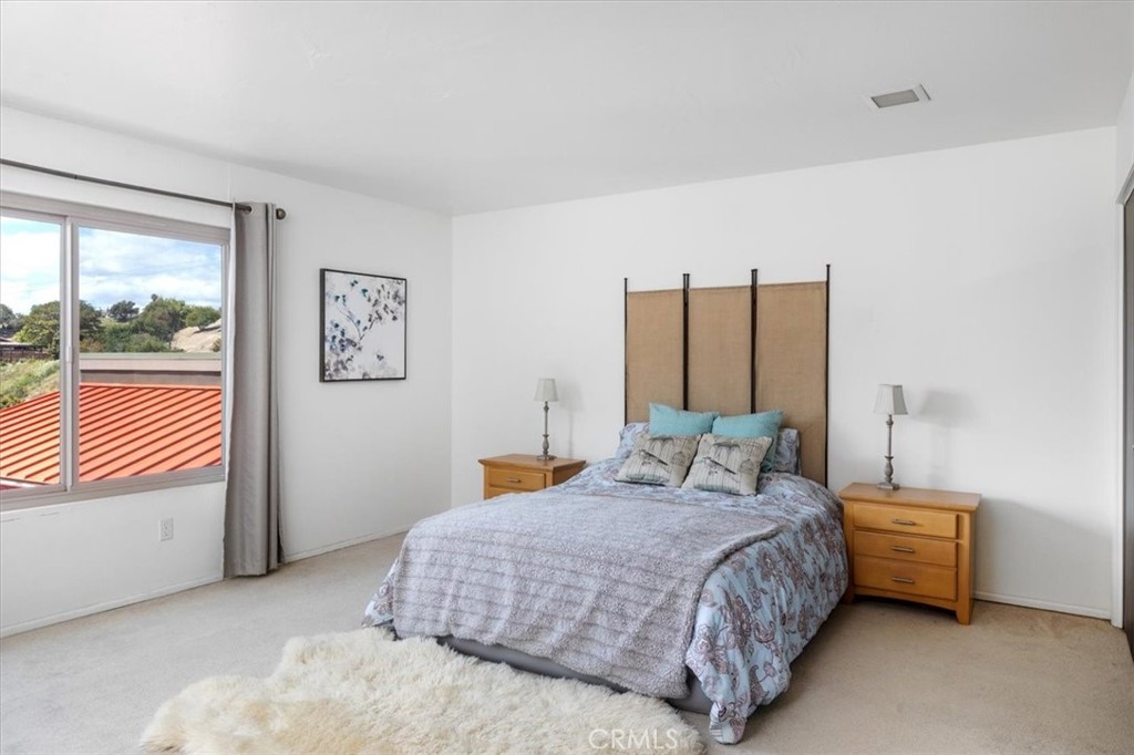 3240 Skycrest Drive Fallbrook, CA 92028 - Photo 25 of 40 a bedroom with a bed and a dresser next to a window