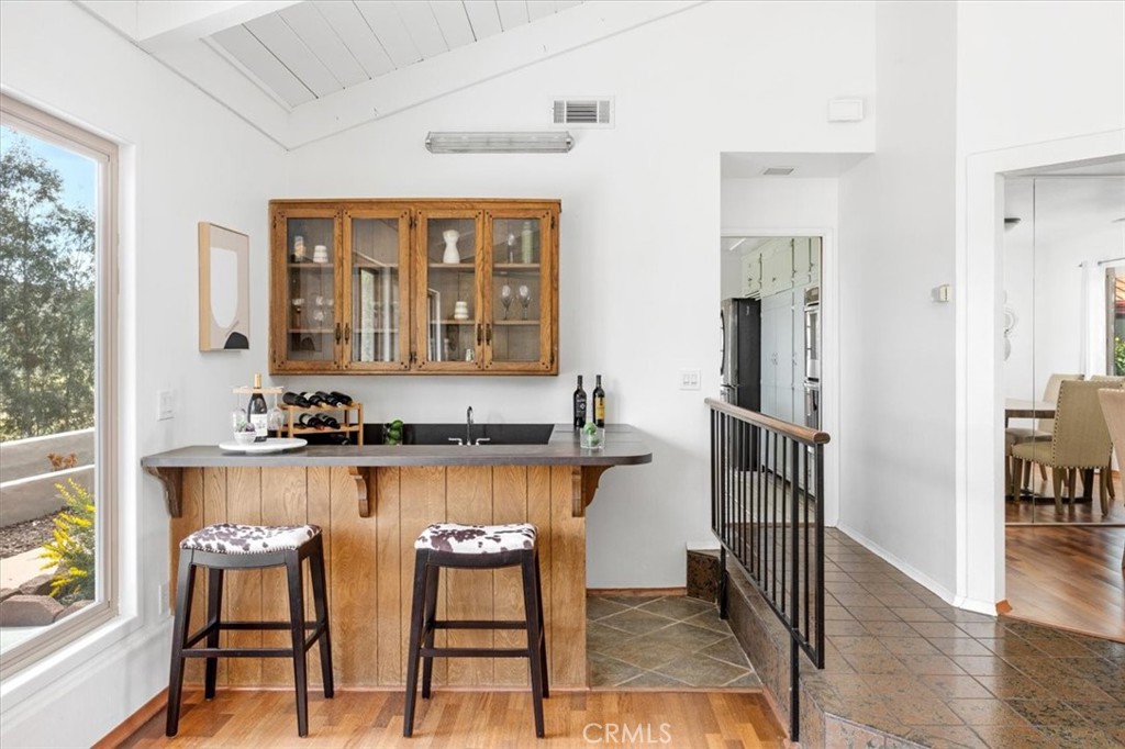 3240 Skycrest Drive Fallbrook, CA 92028 - Photo 7 of 40 a kitchen with granite countertop wooden floors and white cabinets
