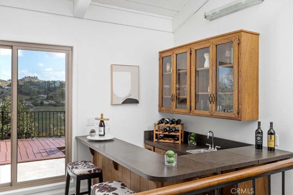 3240 Skycrest Drive Fallbrook, CA 92028 - Photo 8 of 40 a kitchen with a table chairs stove and wooden floor