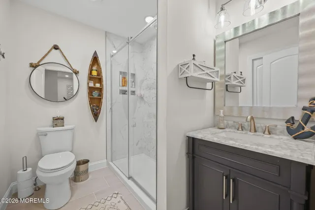 a bathroom with a granite countertop double vanity sink and a mirror