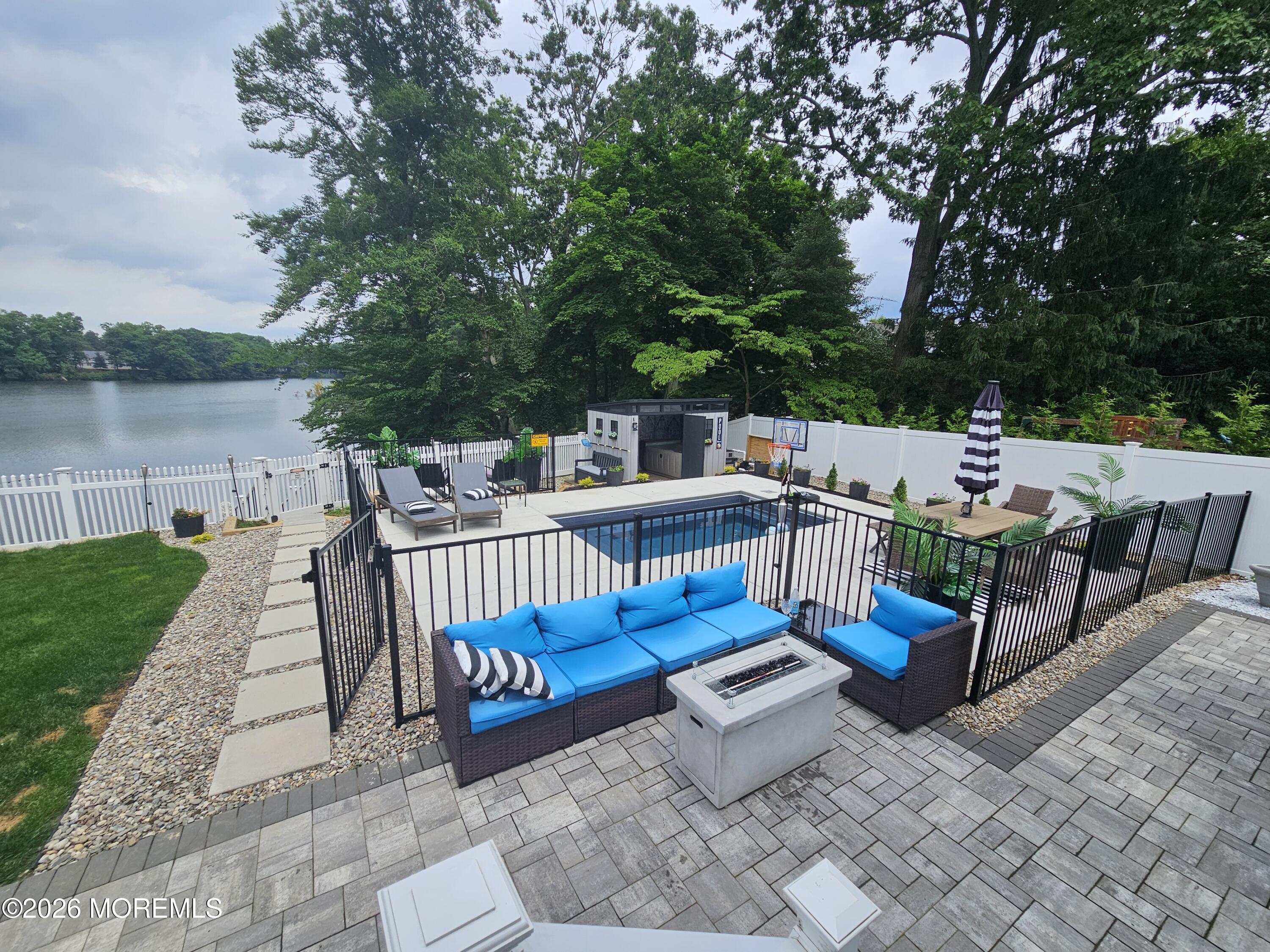91 Davis Lane Red Bank, NJ 07701 - Photo 45 of 87 a view of a patio with couches chairs and a table of the ocean