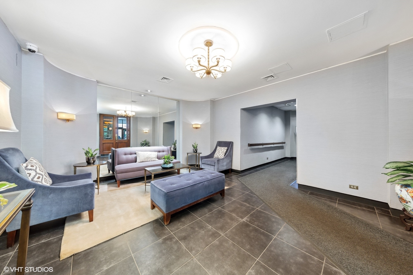720 West Gordon Terrace, Unit 14F Chicago, IL 60613 - Photo 12 of 17 a living room with furniture and a chandelier