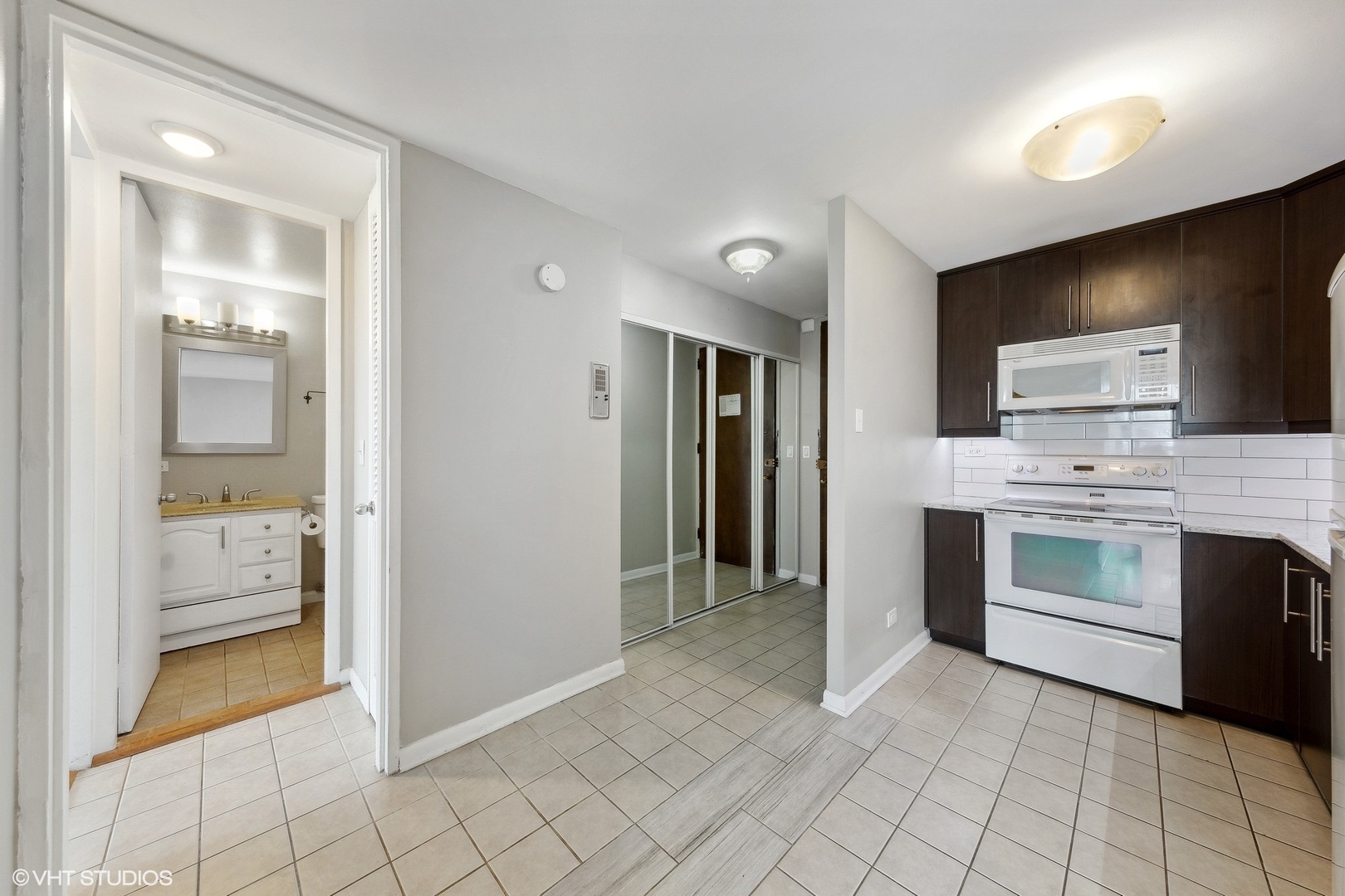 720 West Gordon Terrace, Unit 14F Chicago, IL 60613 - Photo 16 of 17 a view of a kitchen with a sink and a stove top oven