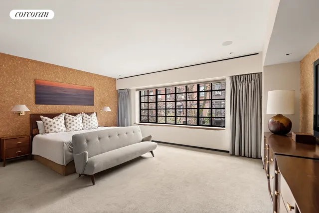 a spacious bedroom with a bed and a large window