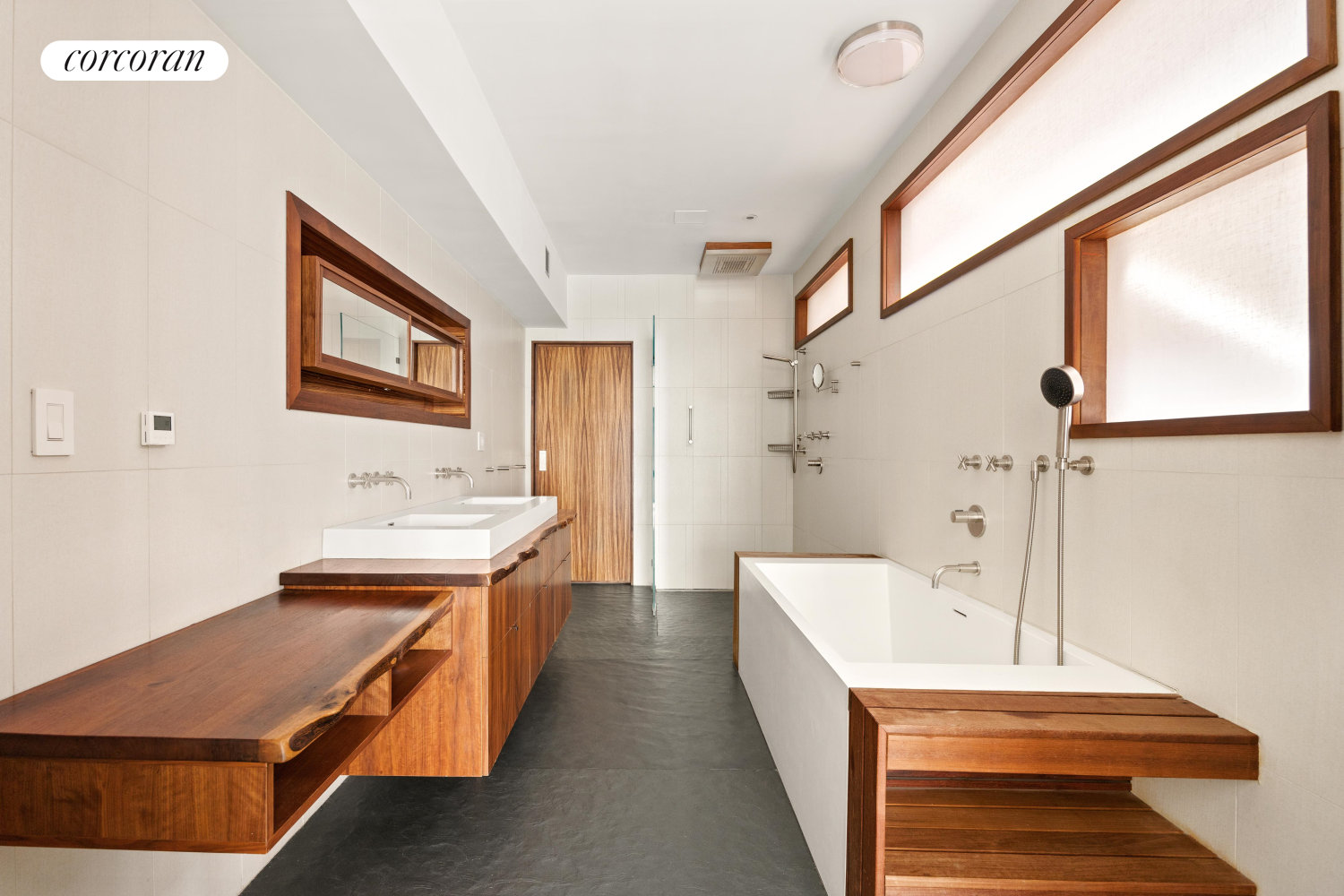 52 Sidney Place Brooklyn, NY 11201 - Photo 13 of 28 a hallway with a white cabinets and wooden floor