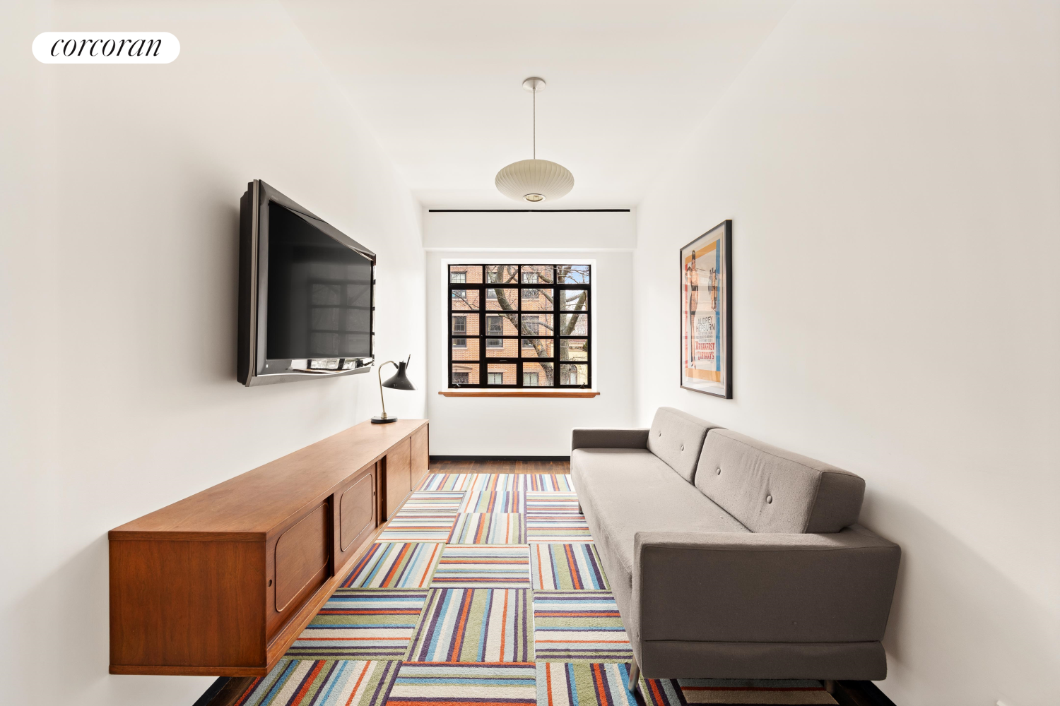 52 Sidney Place Brooklyn, NY 11201 - Photo 24 of 28 a living room with furniture and a flat screen tv