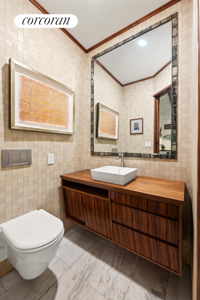 52 Sidney Place Brooklyn, NY 11201 - Photo 25 of 28 a bathroom with a toilet a sink and mirror