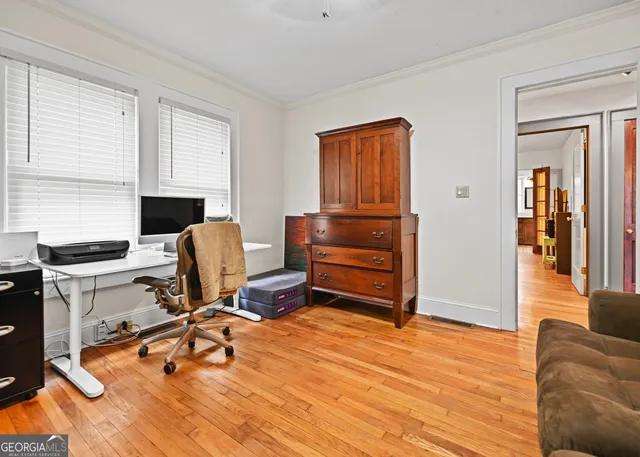 a view of workspace with wooden floor windows