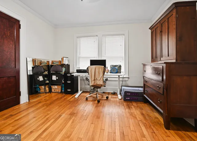 a view of a workspace with furniture and wooden floor