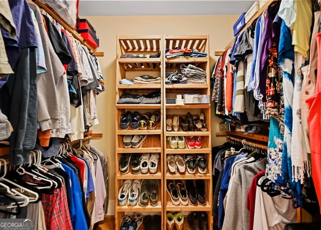 a spacious bedroom with a bed and a chandelier