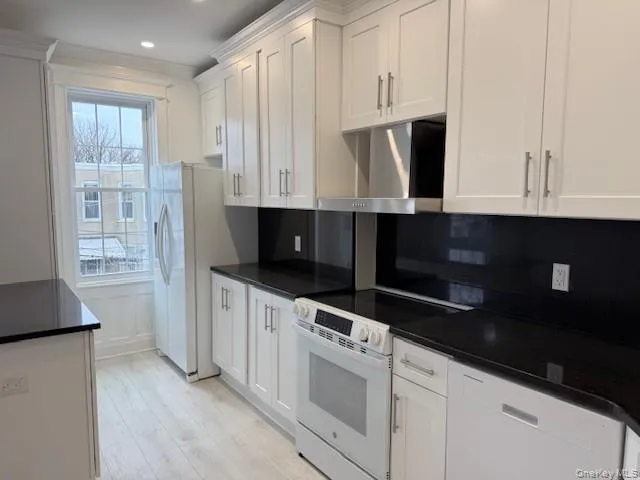 a kitchen with stainless steel appliances a sink a stove and cabinets
