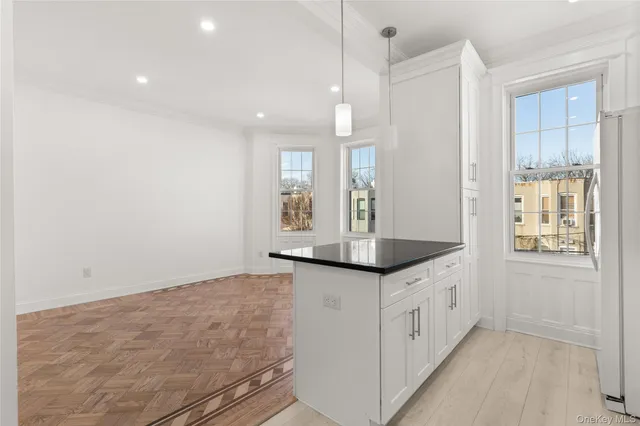 a bathroom with granite countertop a sink a toilet and large mirror
