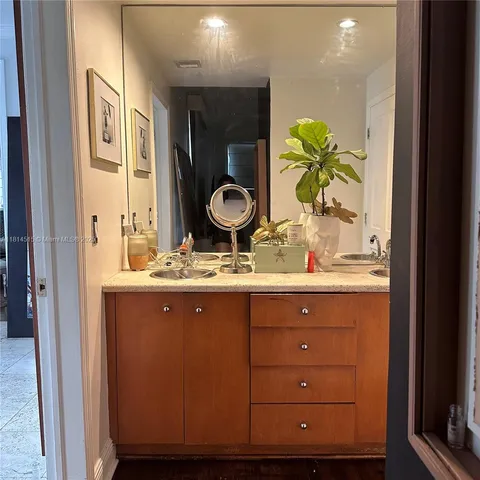 a bathroom with a granite countertop sink a vanity and a mirror