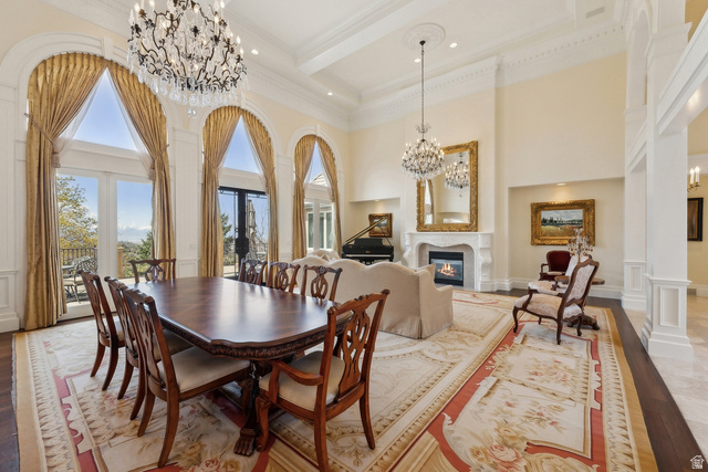 1714 Ridge Point Drive Bountiful, UT 84010 - Photo 33 of 132 Grand living space featuring vaulted ceilings, arched windows with exterior access, a built-in fireplace, and ornate chandeliers