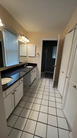a kitchen with a sink a counter and cabinets