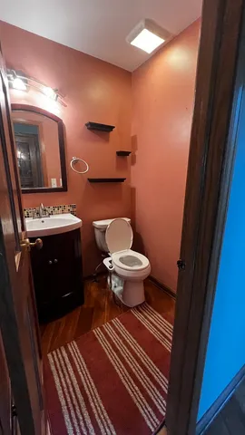 a bathroom with a sink toilet and mirror