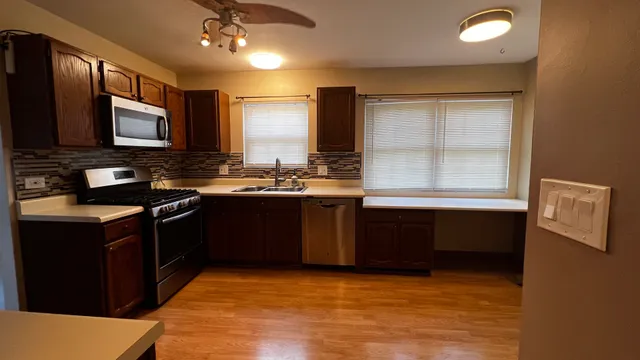 a kitchen with a sink stove and microwave