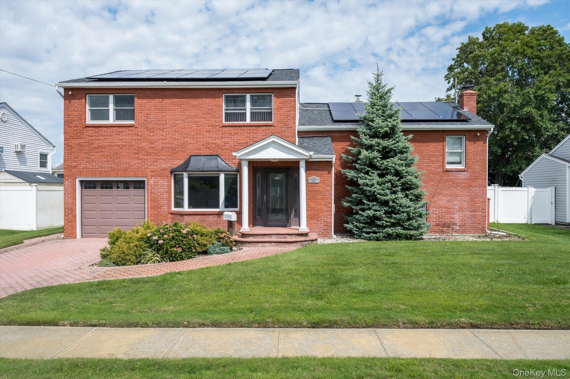 40 Bayview Place Massapequa, NY 11758 - Photo 1 of 1 a front view of a house with a garden