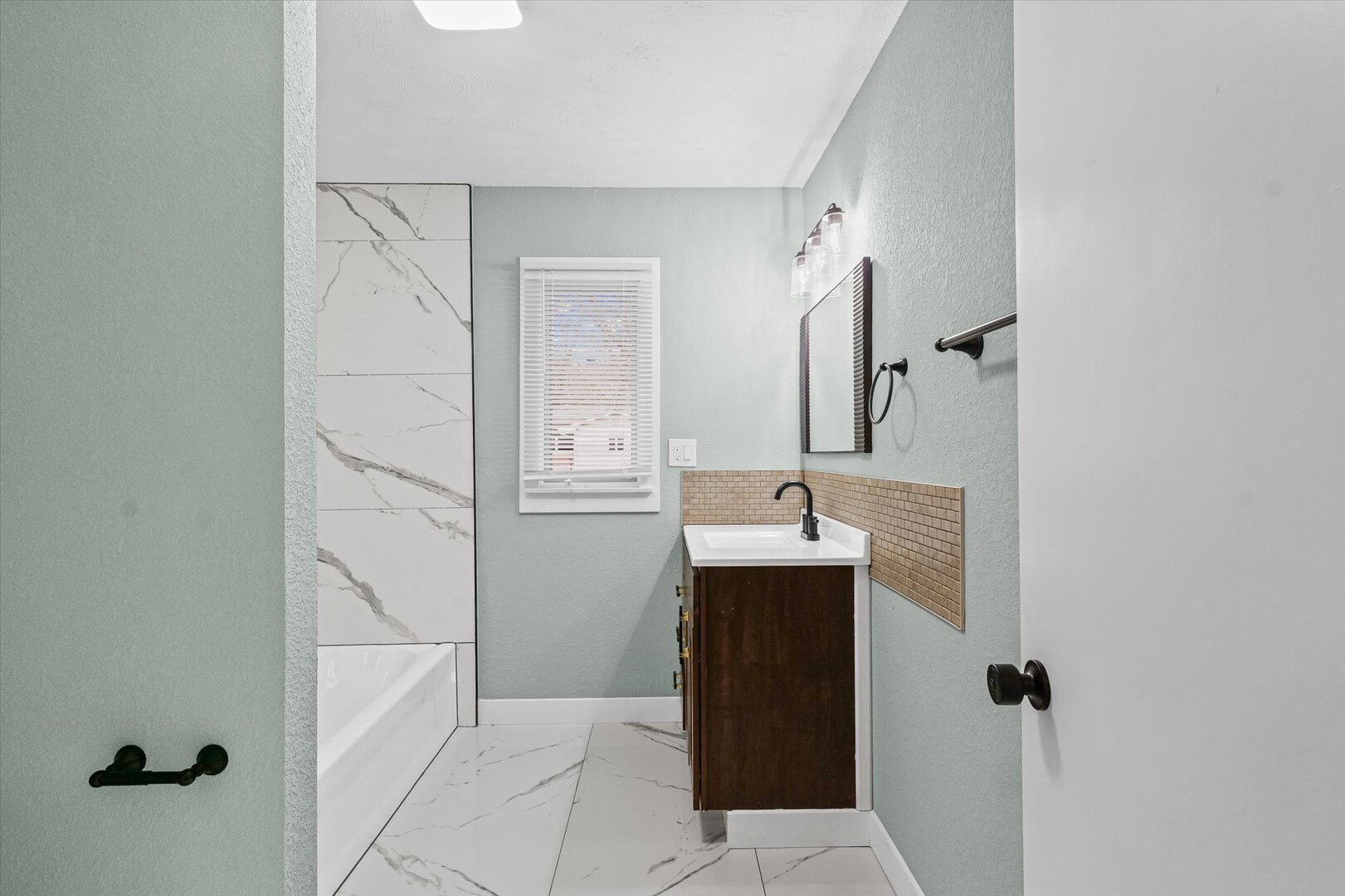 10 East Locust Street Ashmore, IL 61912 - Photo 17 of 28 a bathroom with a sink and mirror