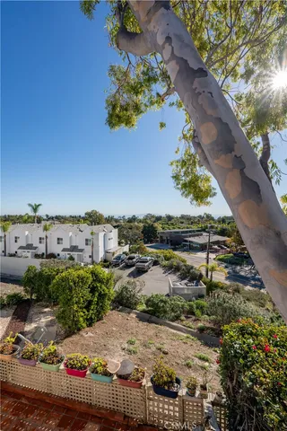 an aerial view of a house with a yard and mountain view in back