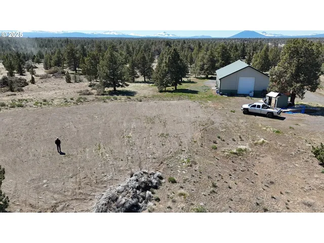 a view of a dry yard with mountain view