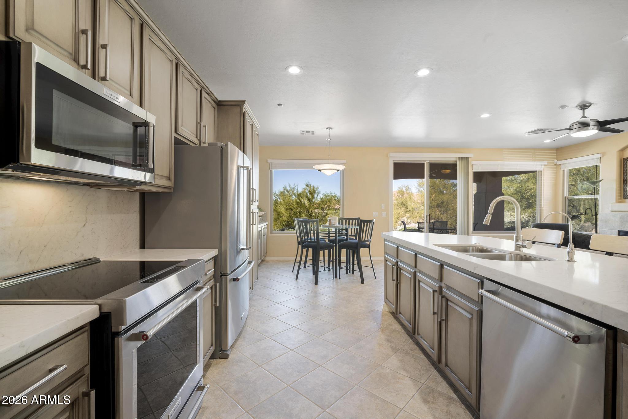 11448 East Raintree Drive Scottsdale, AZ 85255 - Photo 13 of 37 a kitchen with appliances cabinets and furniture