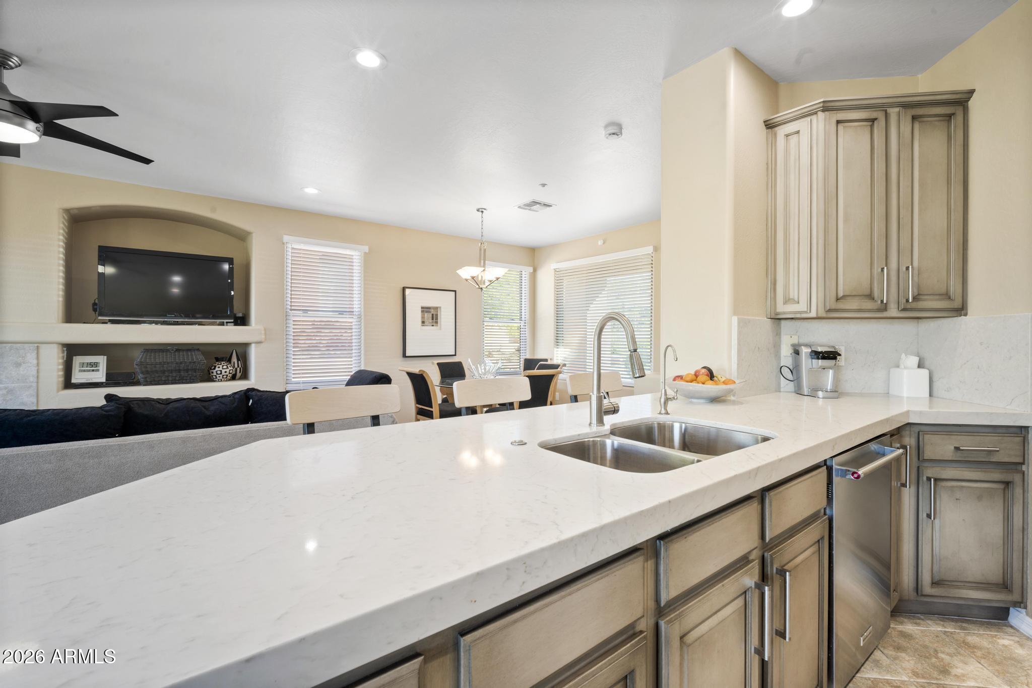 11448 East Raintree Drive Scottsdale, AZ 85255 - Photo 14 of 37 a kitchen with stainless steel appliances a sink a stove and a wooden floors